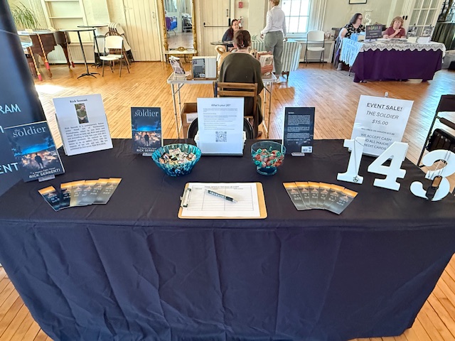 Rick's author table at Books in Bloom with The Soldier on display